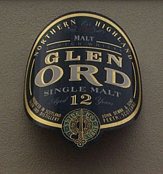 A brass sign painted in blue with golden letters on it. "Glen Ord"